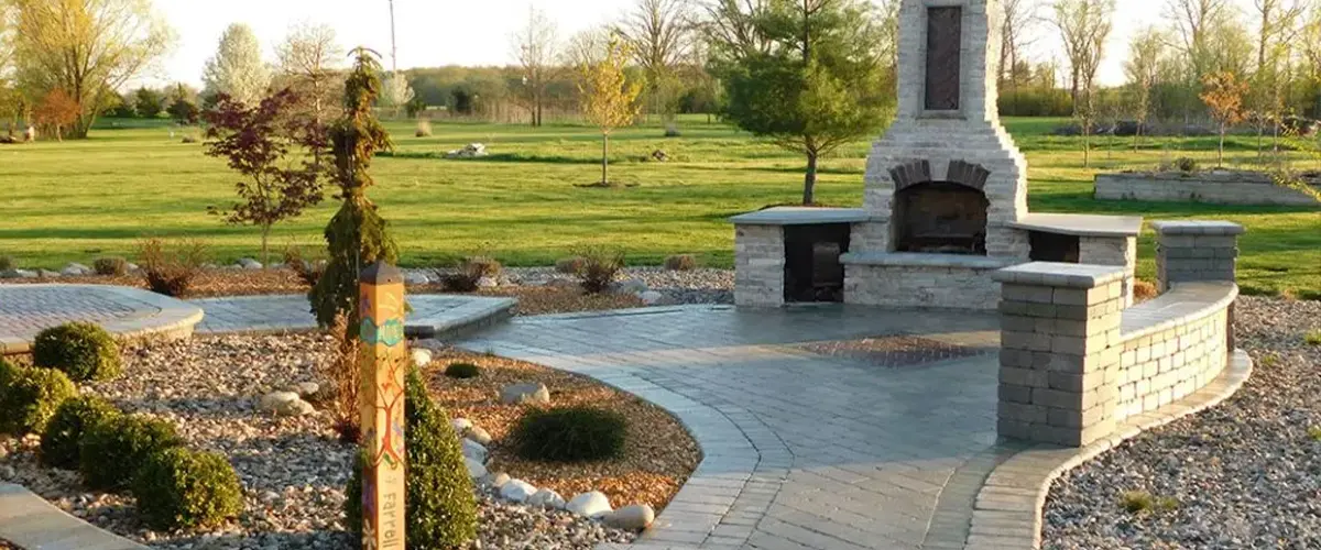 Smaller patio with pathways and fireplace