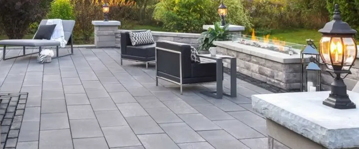 Stone tiled patio with rectangular fire pit