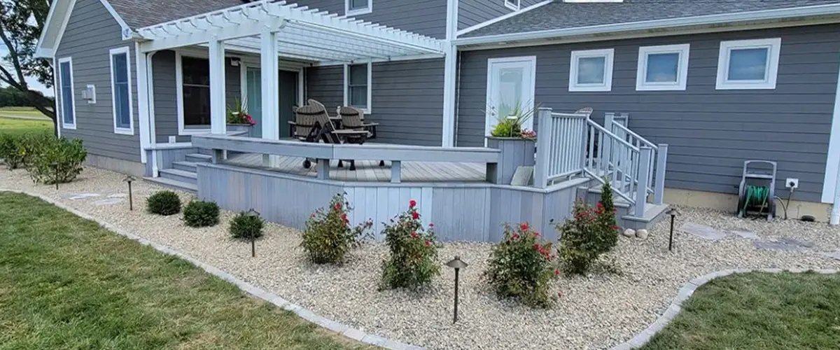 Planting Services Gallery - house with gravel and flowers around it