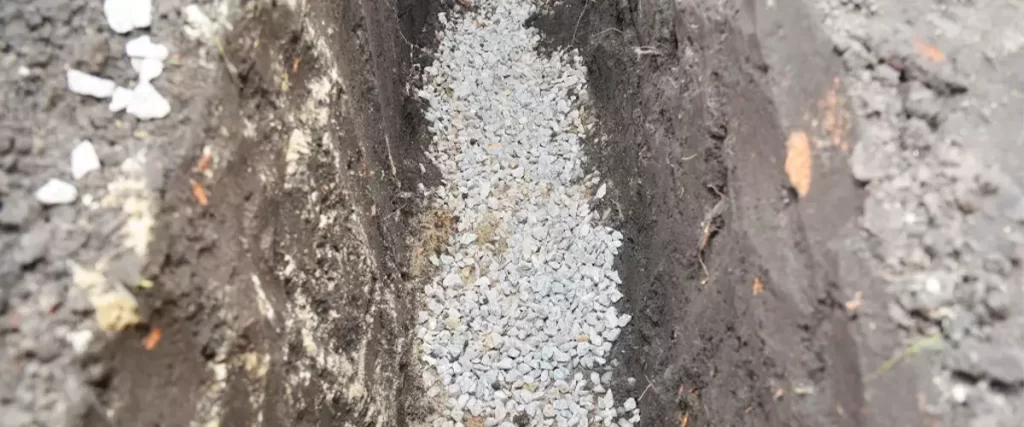 A deep trench filled with stone gravel