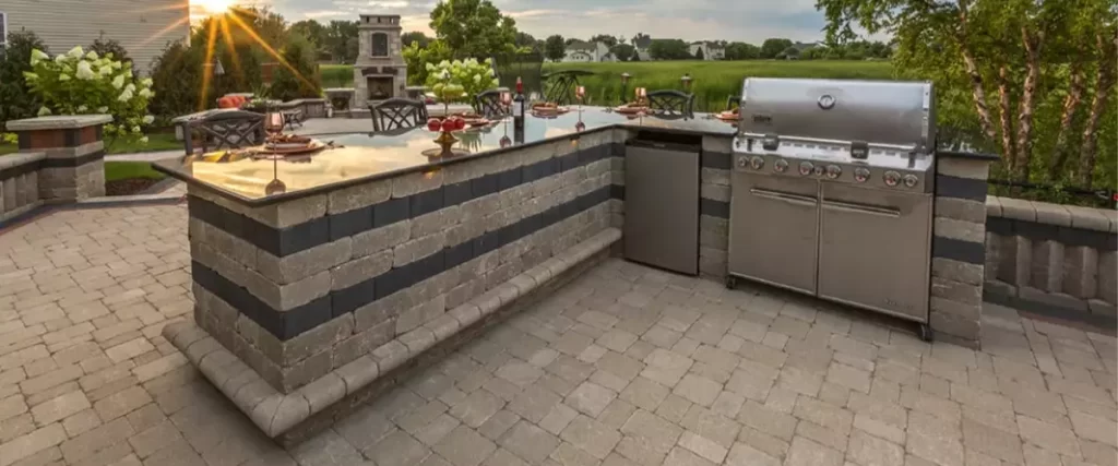 An outdoor kitchen in an outdoor living space.