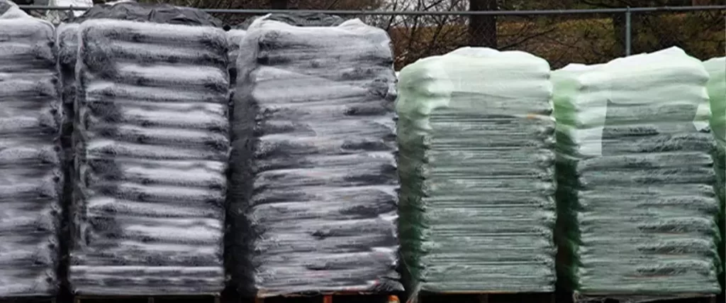 Pallets piled with bags of soil