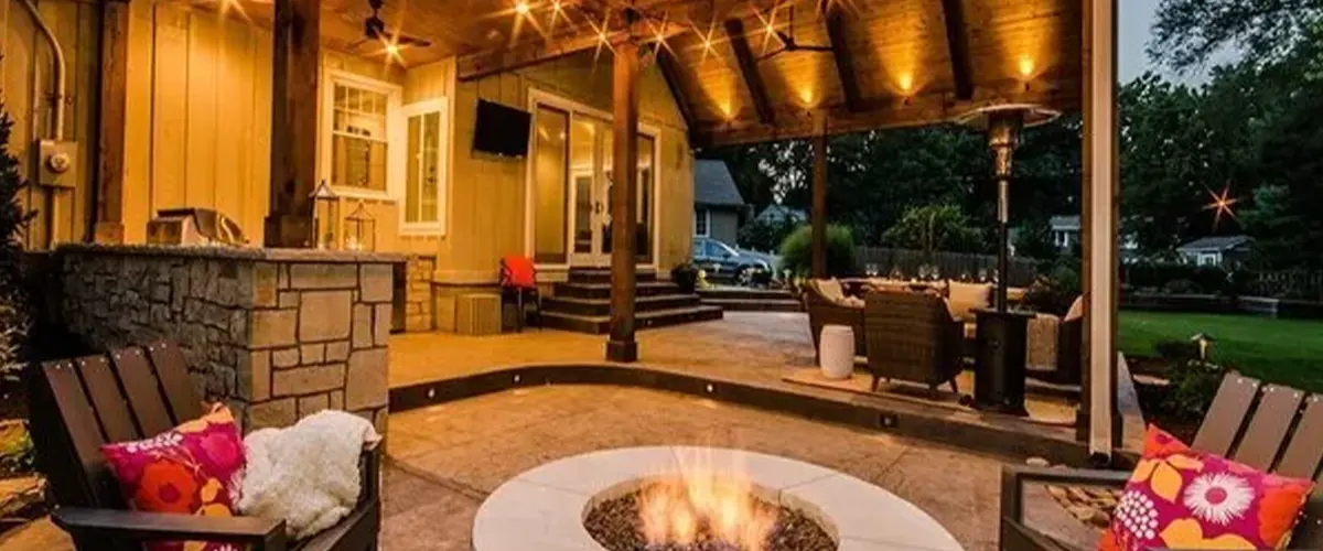 Outdoor living space with fire pit and string lights