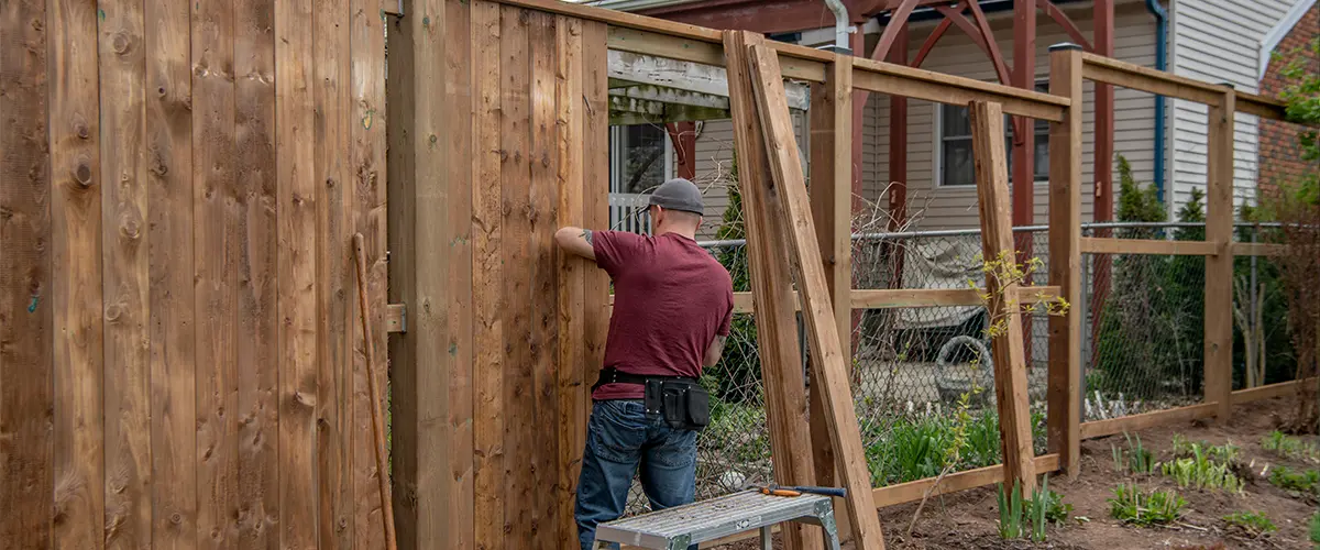 A man installing a fence in Bryan, Ohio