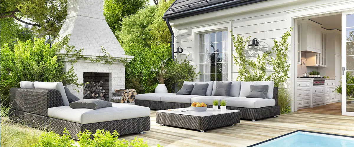 A large fireplace on a deck with outdoor furniture