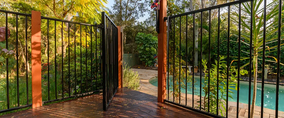 Aluminum fence in a backyard with a pool