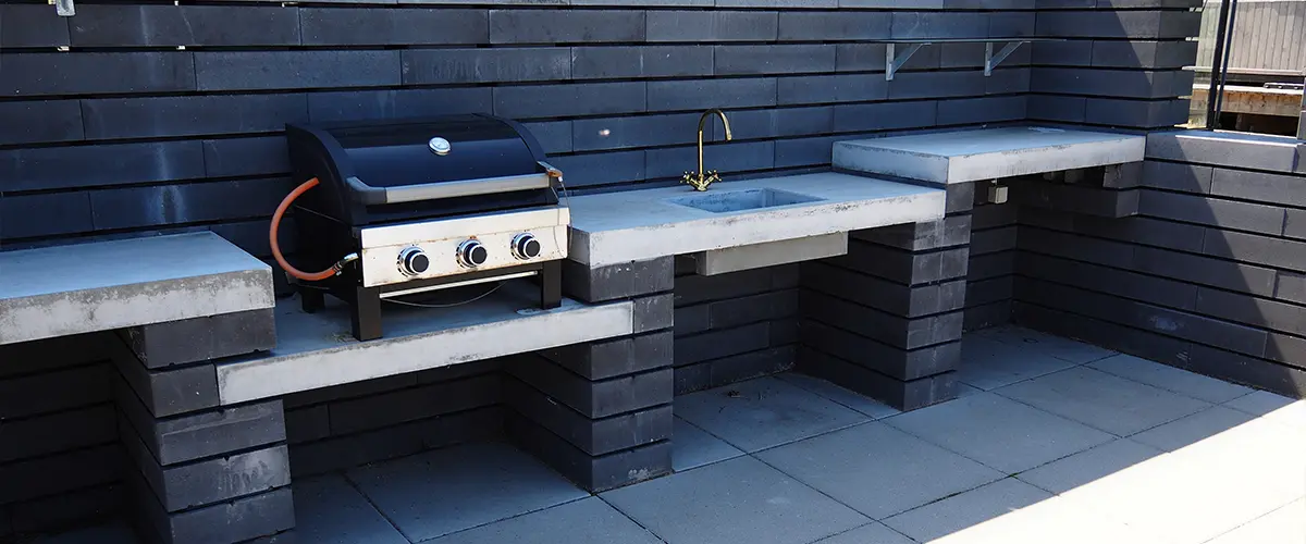 Modern outdoor kitchen with a small grill