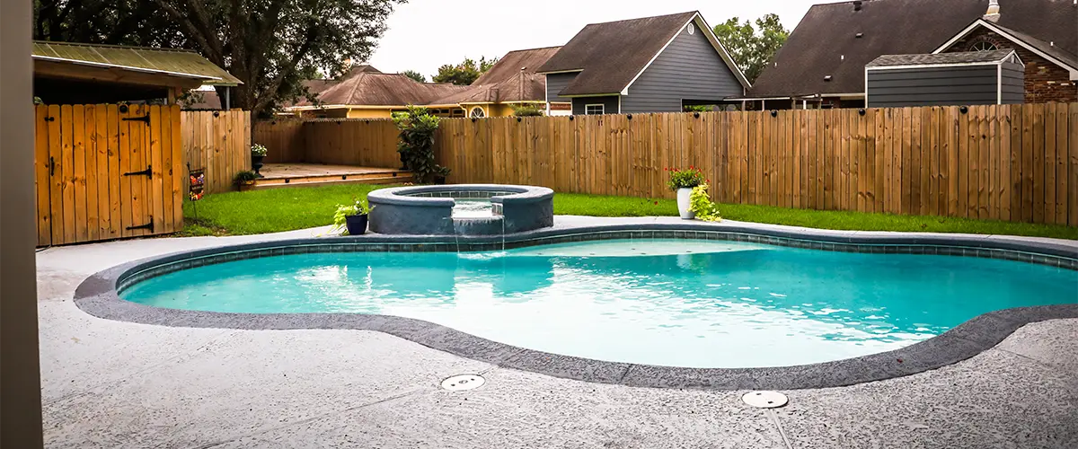 A pool construction with a cedar fence