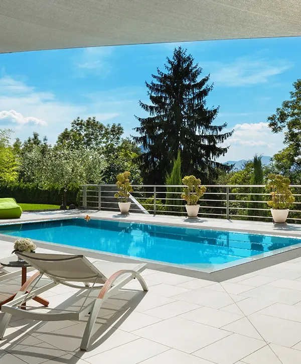 A pool in a backyard with steel railing