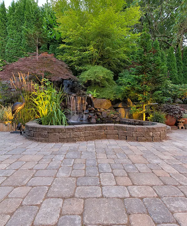 A water feature with a paver patio