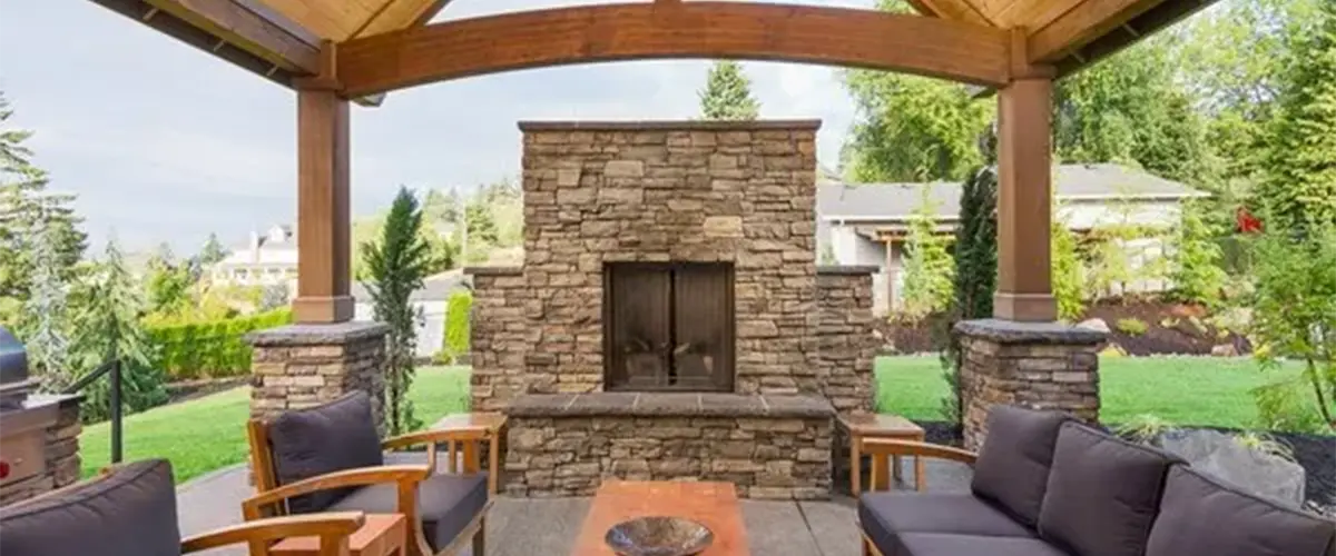 Outdoor living space with patio and roof structure and fireplace