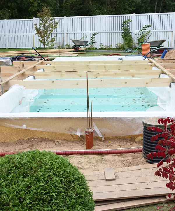 Fiberglass swimming pool construction building. Garden or backyard landscape works for swimming pool installation. The Best Pool Installation In Napoleon, OH