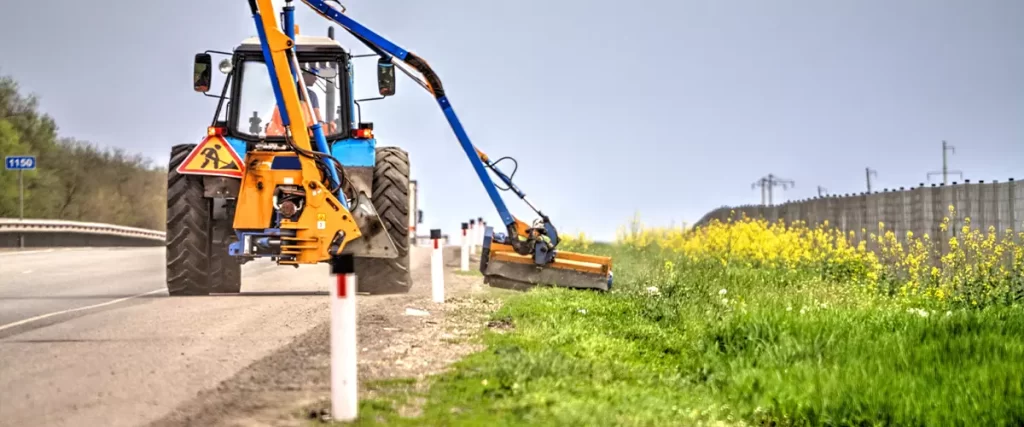 Tractor with a mechanical mower mowing grass