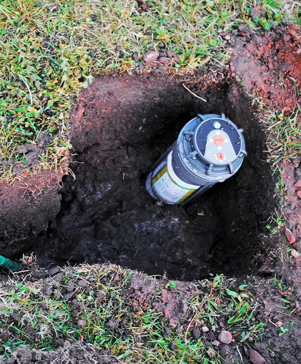 Sprinkler System Being Installed In Dogged Holes