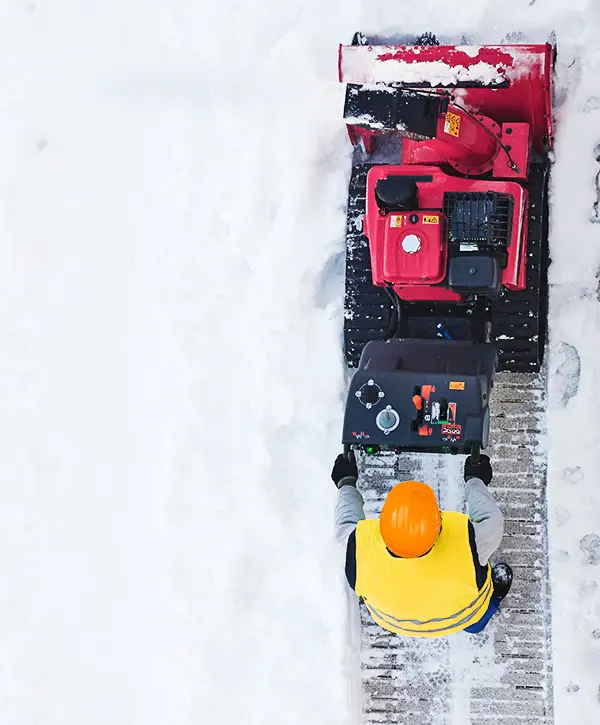 Man Removing Ice Snow With Machine in Bryan OH