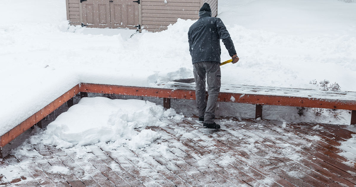 Man Shoveling Snow Off Deck in Ohio