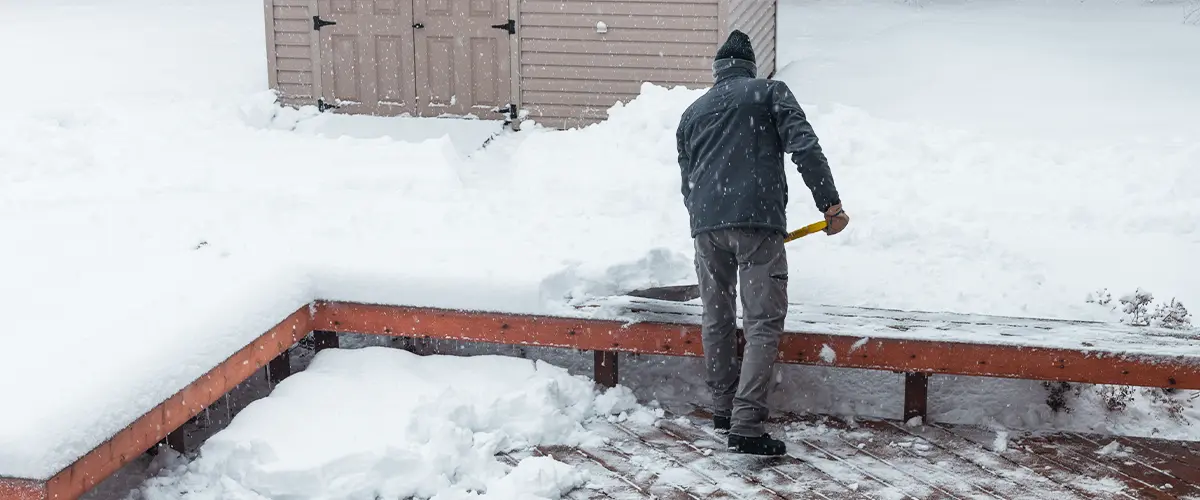 Man Shoveling Snow Off Deck in Ohio