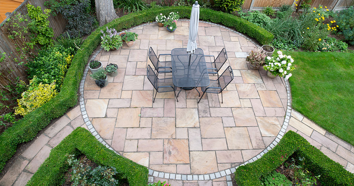 Circular garden patio with freshly jet washed paving stones