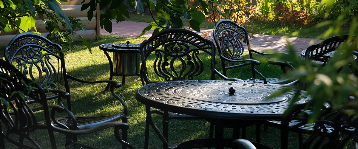 Garden chairs and table metal openwork forged in the summer garden